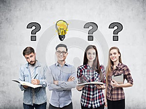 Young business team, questions and bulb