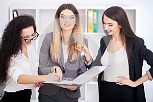 Young business team reading sticky notes on the work desk in off