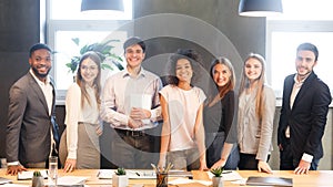 Young business team smiling to camera, having break