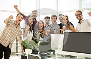 Young business team is unpacking boxes in a new office