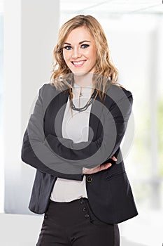 Young business woman with arms crossed, smile