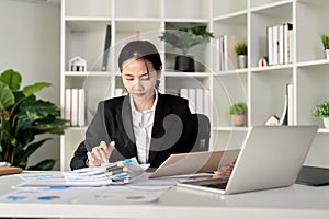 Young business woman asian or employee accounting bookkeeping documents checking financial data or marketing report