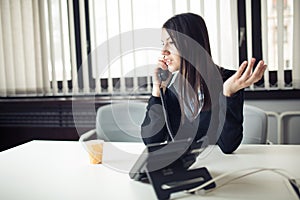 Young business woman calling and communicating with partners. Customer service representative on the phone