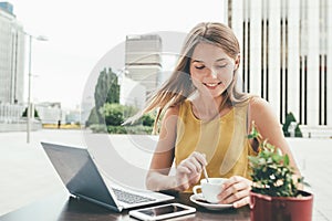 Young business woman on the computer drinking a coffee