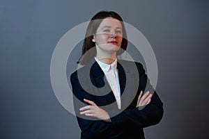 Young Business woman with crossed arms looking to camera. Confident successful woman looking to camera