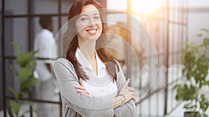 young business woman crossed her arms and posing at the camera