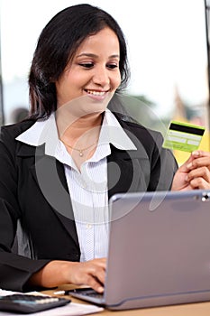 Young business woman doing online shopping