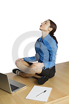 Young business woman doing yoga