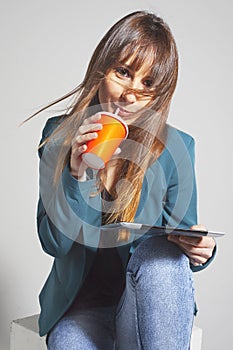 Young business woman drinking refreshment using straw