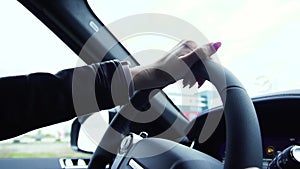 Young business woman driver driving a car on a highway. Stock. Close up young beautiful woman driving a luxury car on