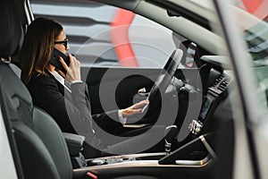 Young business woman driving in her car to work. Successful business concept. business woman driving