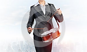 Young business woman with a drum