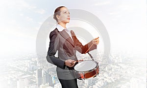 Young business woman with a drum