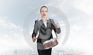 Young business woman with a drum