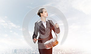 Young business woman with a drum