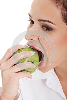 Young business woman eating apple.