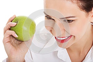 Young business woman eating apple.