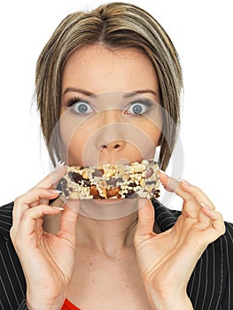 Young Business Woman Eating a Breakfast Cereal Bar