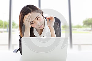 Young business woman feel tired and holding head