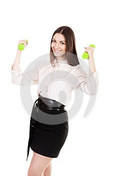 Young business woman in formalwear lifts dumbbells