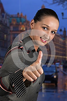 Young business woman give thumbs up