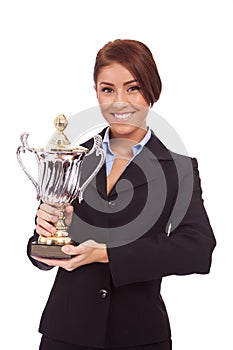 Young business woman holding her big trophy