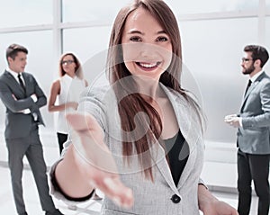 Young business woman holding out her hand for a handshake