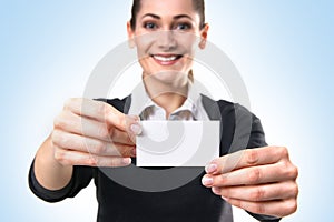 A young business woman holding a visit card