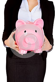 Young business woman holiding piggybank