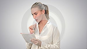 Young business woman inventing ideas, writing the, down to the notebook on white background.