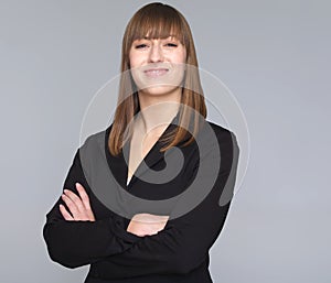 Young business woman isolated on gray background