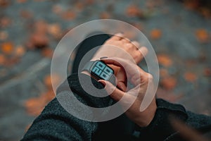 Young business woman is late on time, in a hurry she checks the deadline on her smart watch