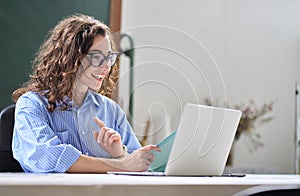 Young business woman leading hybrid online remote video call working in office.