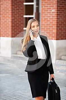 Young business woman leaving her job with hand bag in her hand t