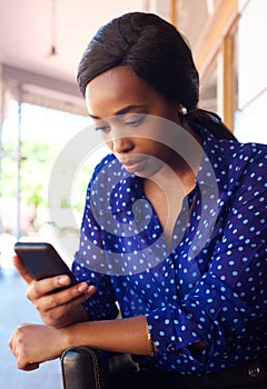 Young business woman looking at cellphone