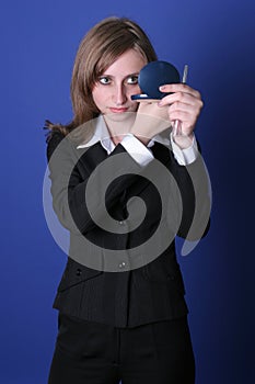 Young business woman looking in a mirror