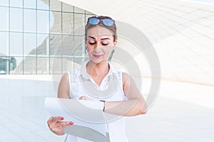 Young business woman looks at his watch and smiles