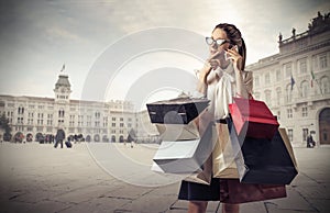 Young business woman with lots of shopping bags