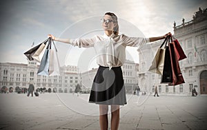 Young business woman with lots of shopping bags