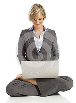 Young Business woman in a lotus pose with laptop