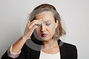 Young business woman made a mistake, studio photo on a white background.