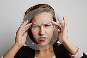 Young business woman made a mistake, studio photo on a white background.