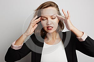 Young business woman made a mistake, studio photo on a white background.