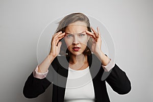 Young business woman made a mistake, studio photo on a white background.