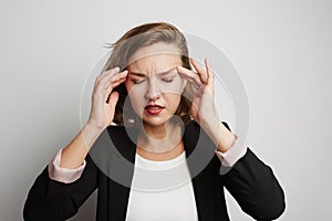 Young business woman made a mistake, studio photo on a white background.