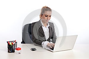 Young business woman at office with laptop