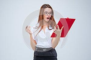 The young business woman with pen and tablet for notes on gray background
