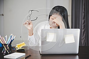 Young business woman person sleepy and has frustration eye problems with cephalalgia disease from using laptop computer on her photo