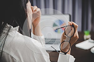 Young business woman person sleepy and has frustration eye problems with cephalalgia disease from using laptop computer on her photo