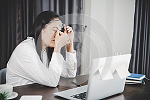 Young business woman person sleepy and has frustration eye problems with cephalalgia disease from using laptop computer on her